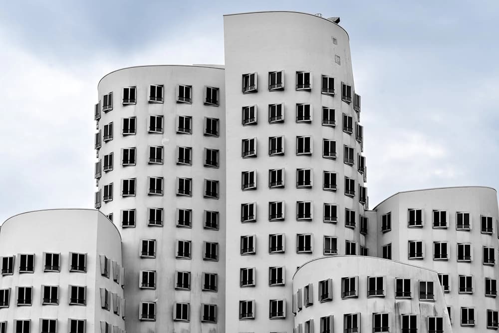 White Gehry against a blue sky in Düsseldorf's Media Harbor.