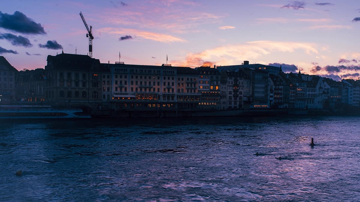 The Grand Hotel Les Trois Rois at dusk, viewed from the river.