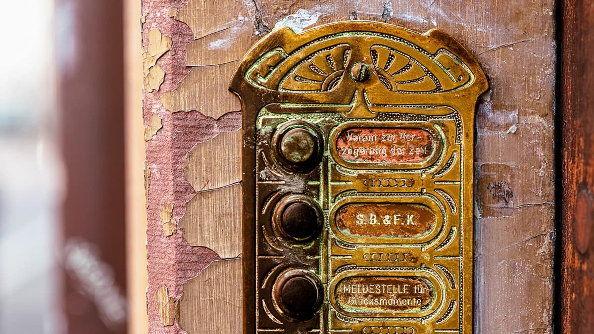 Historic doorbell sign in Basel's old town.