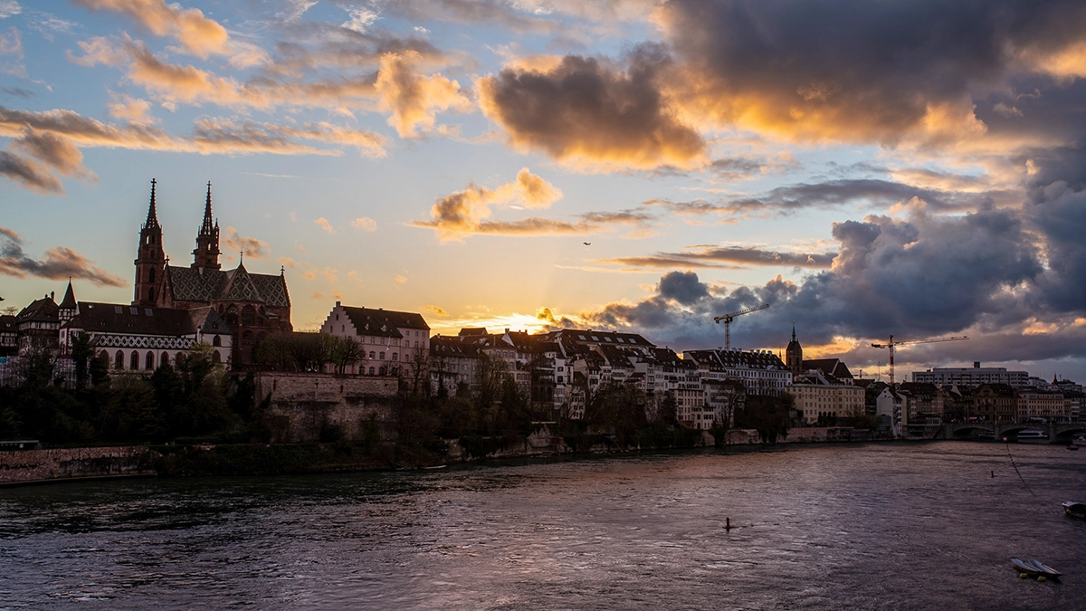 Basel Cathedral from the opposite bank of the river in the evening.
